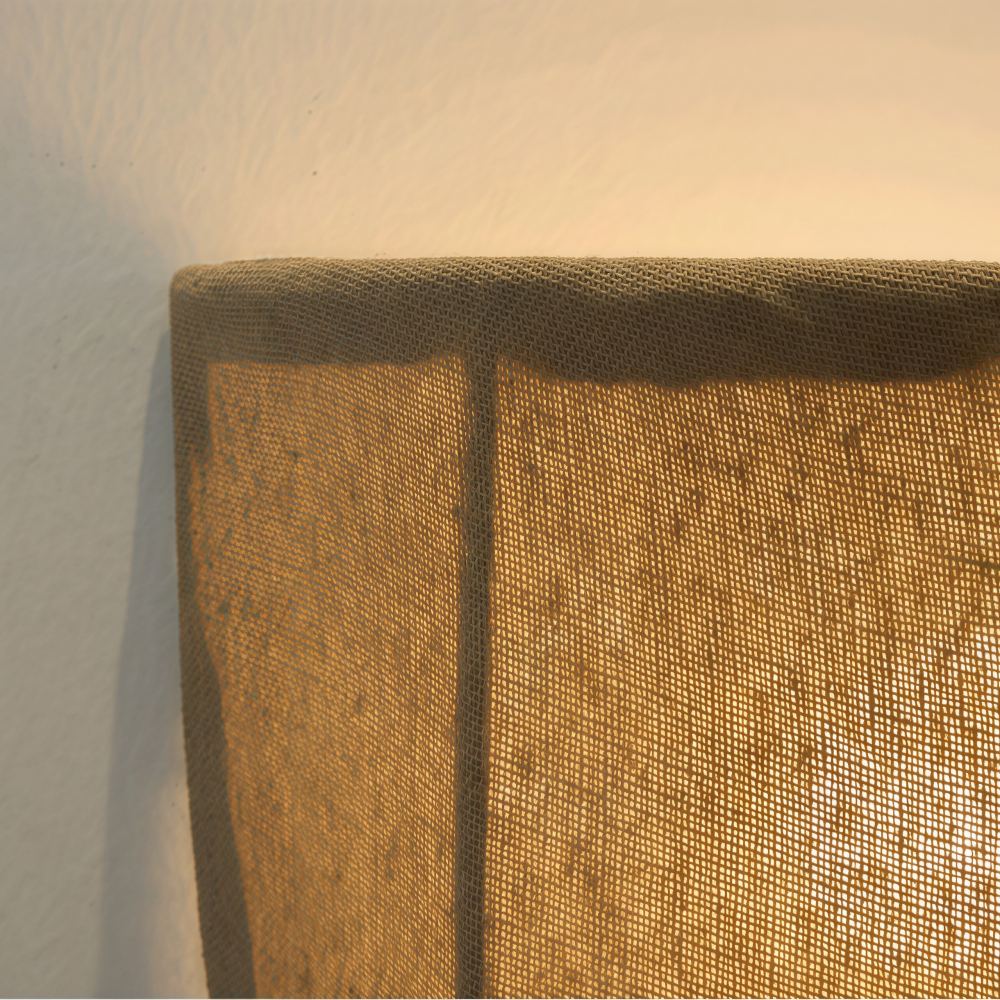 Close view of Fablune shade lit through linen