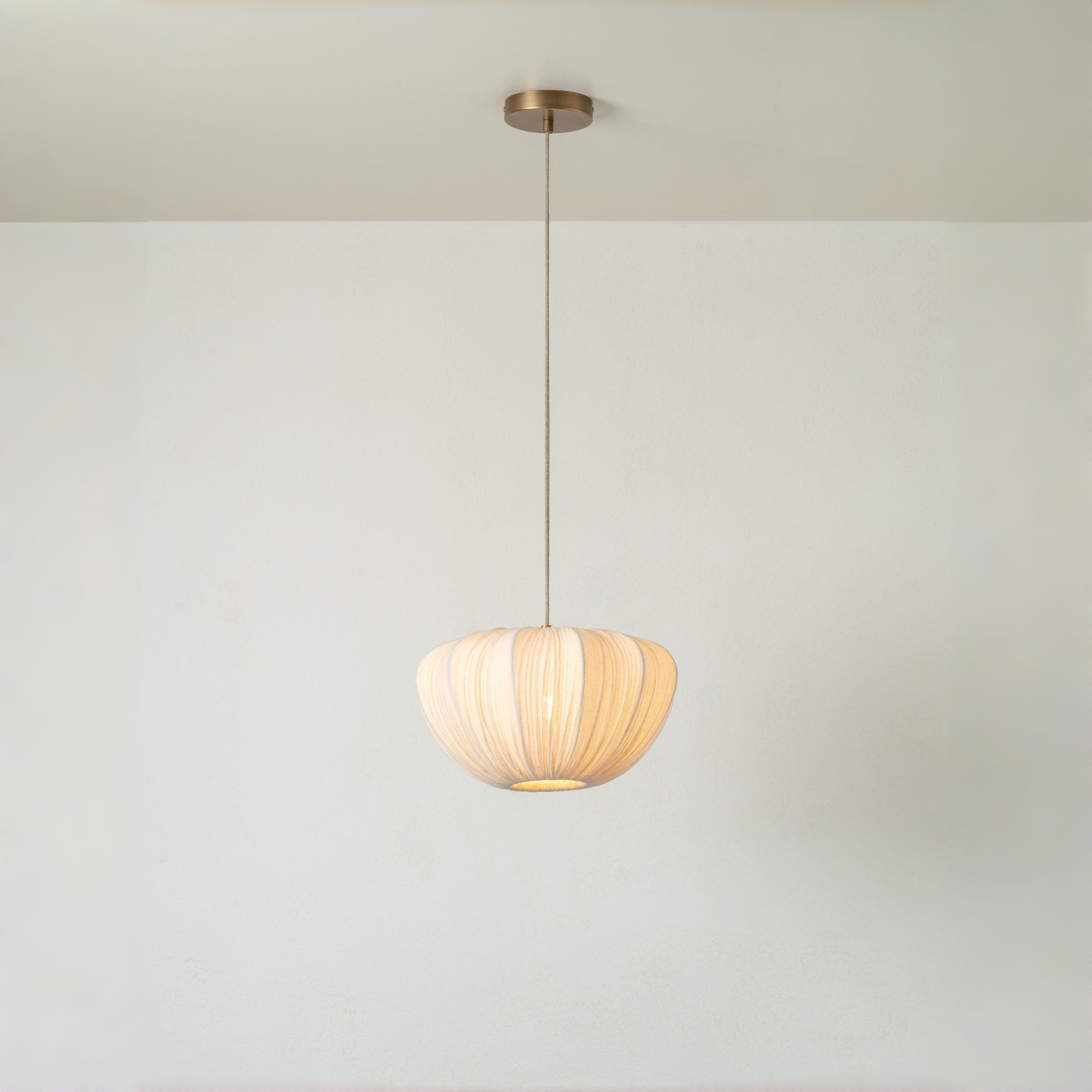 Ostrea pendant shade glowing softly