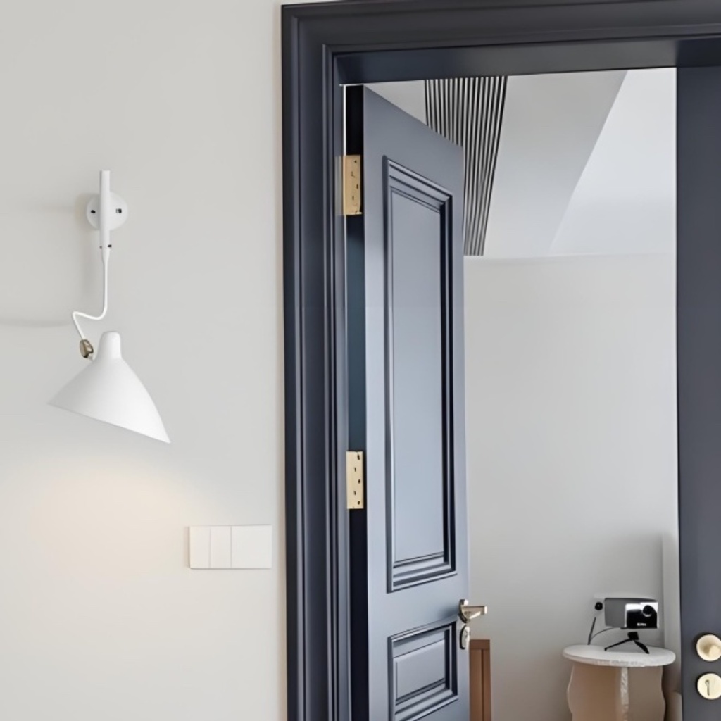 White Arclume wall light near a doorway