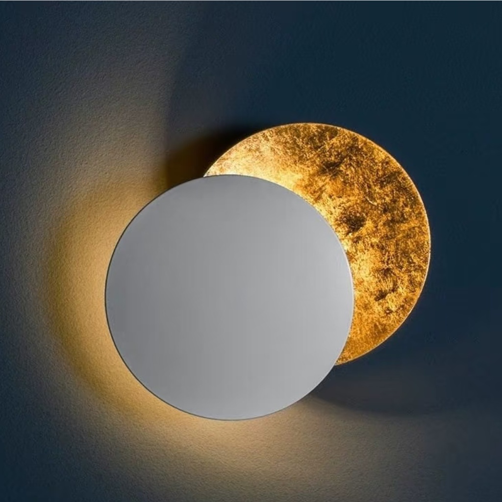 White Discola wall light casting a halo glow