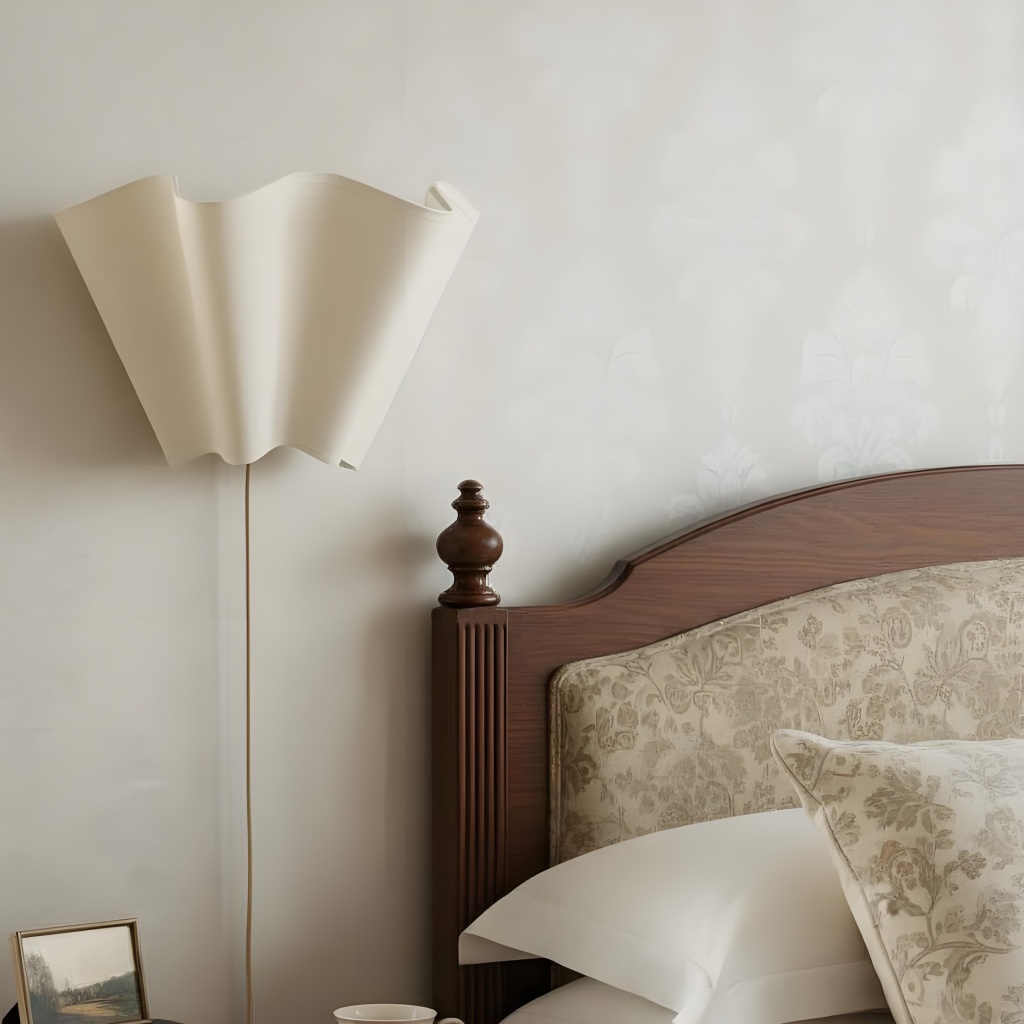 Oslan wall sconce beside a bed