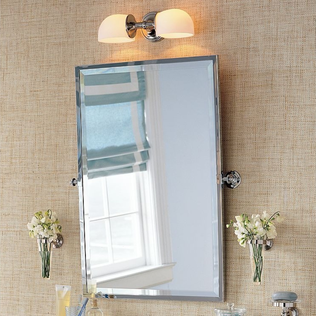 Modern Mercer Double Horizontal Metal Wall Sconce above a mirror with two glass shades