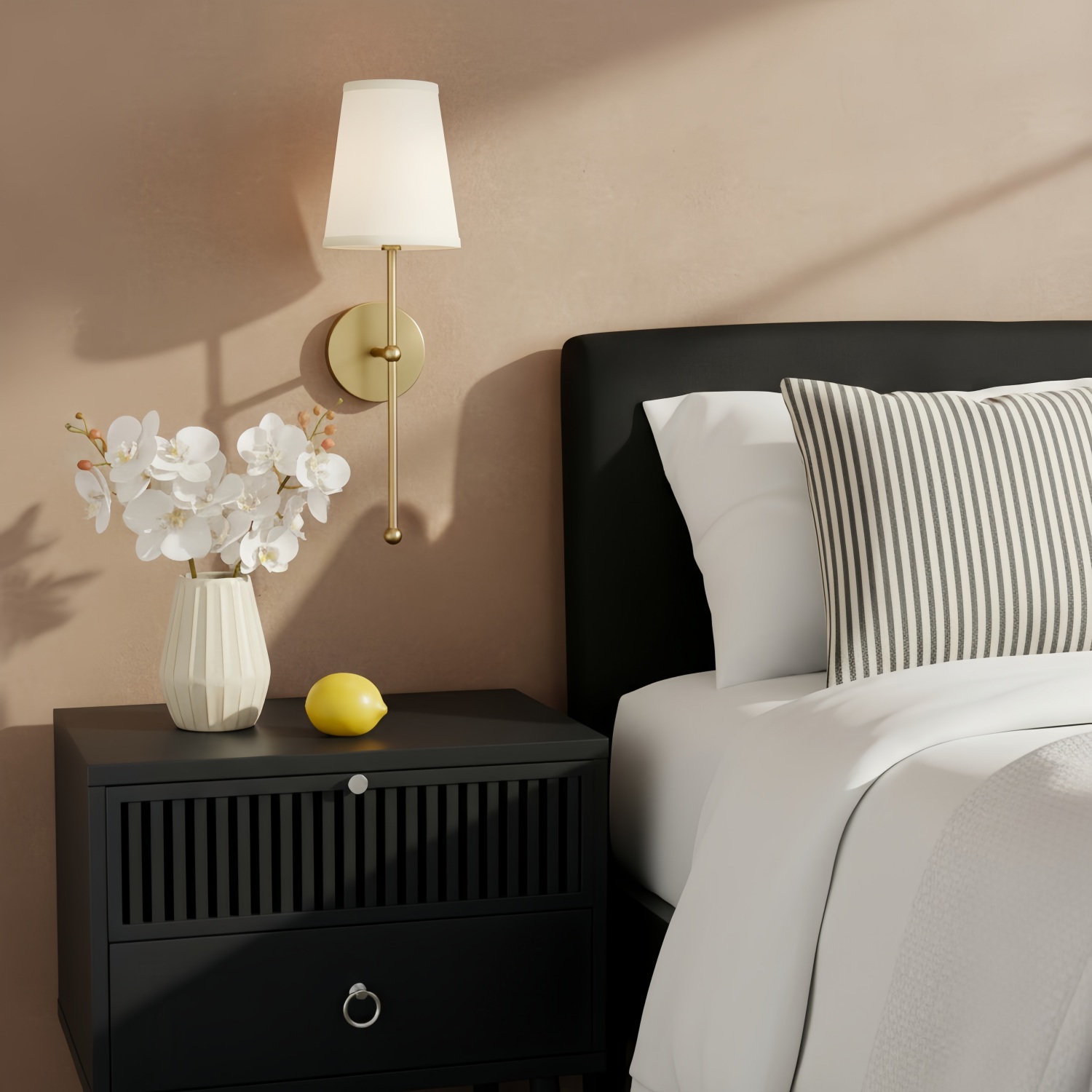 Gold wall lamp beside a bed