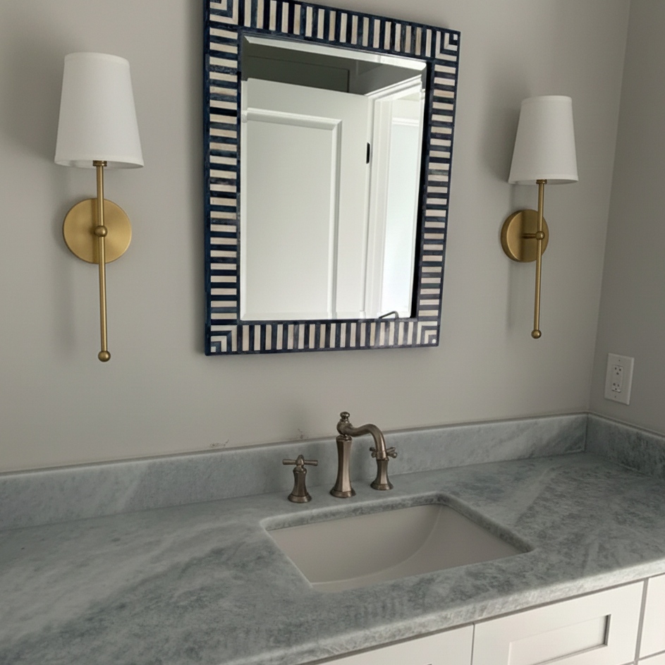 Customer bathroom scene with gold wall lamps
