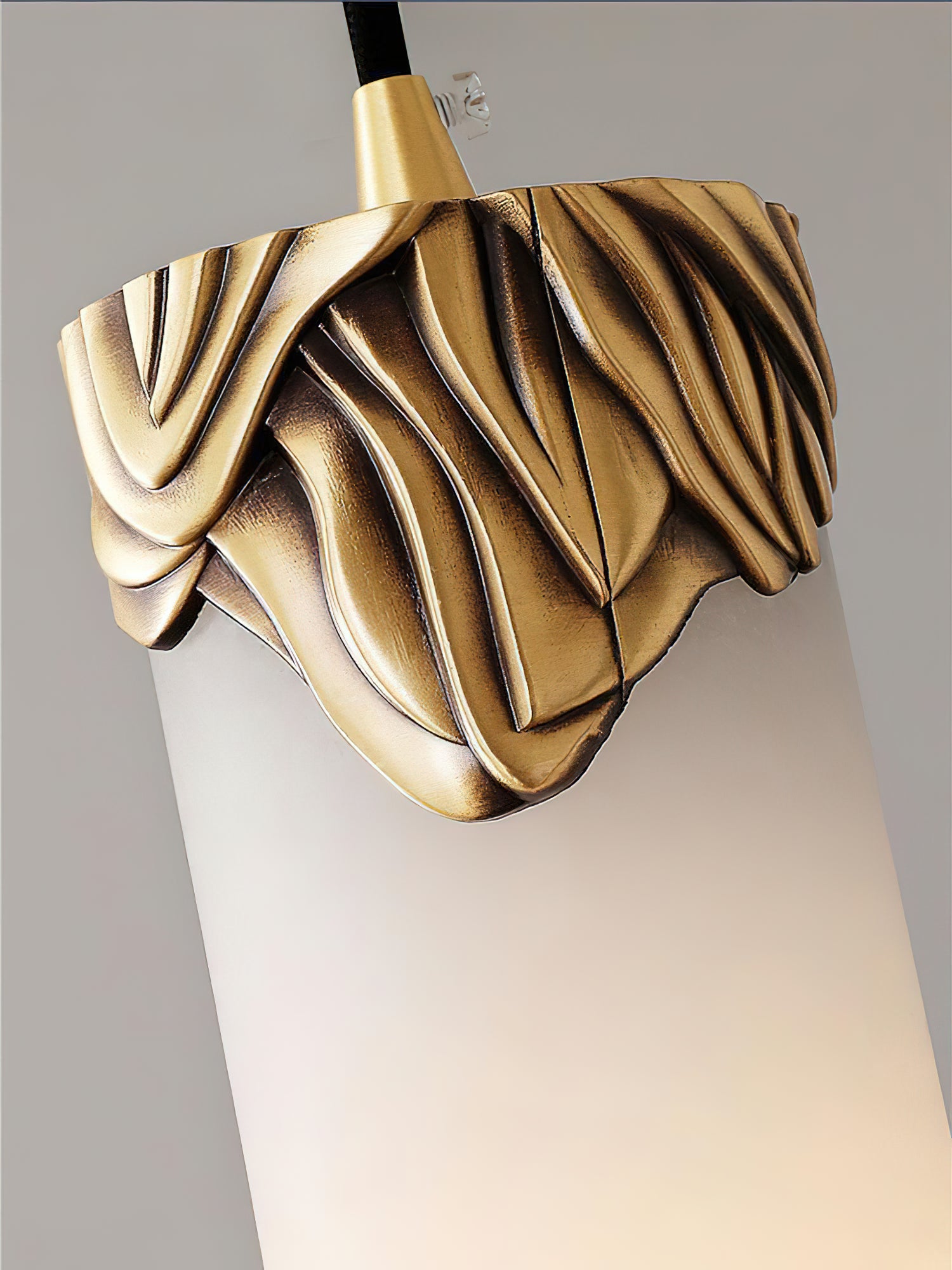 Close view of the folded brass fitting and alabaster shade on the Dansani Lyra pendant light