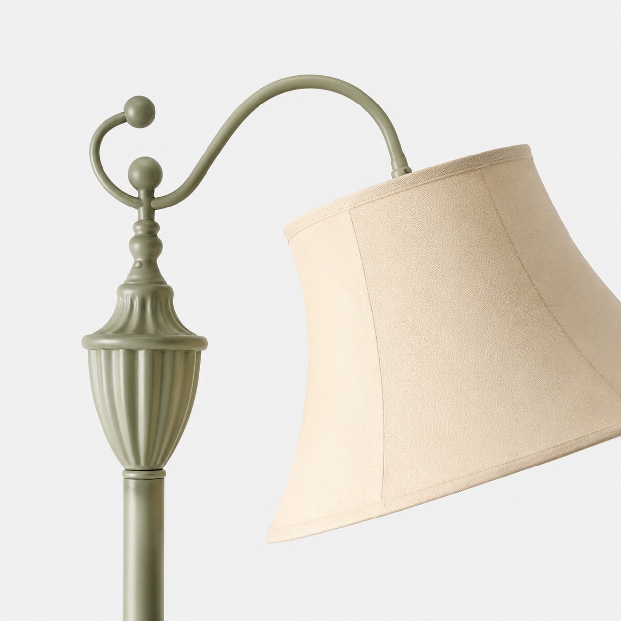 Curved arm ornament and ivory fabric shade detail